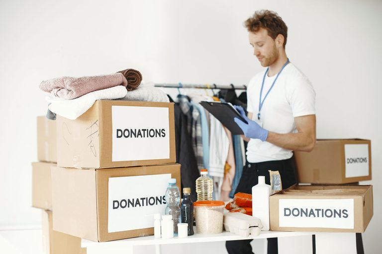 Donation boxes filled with folded clothing and supplies